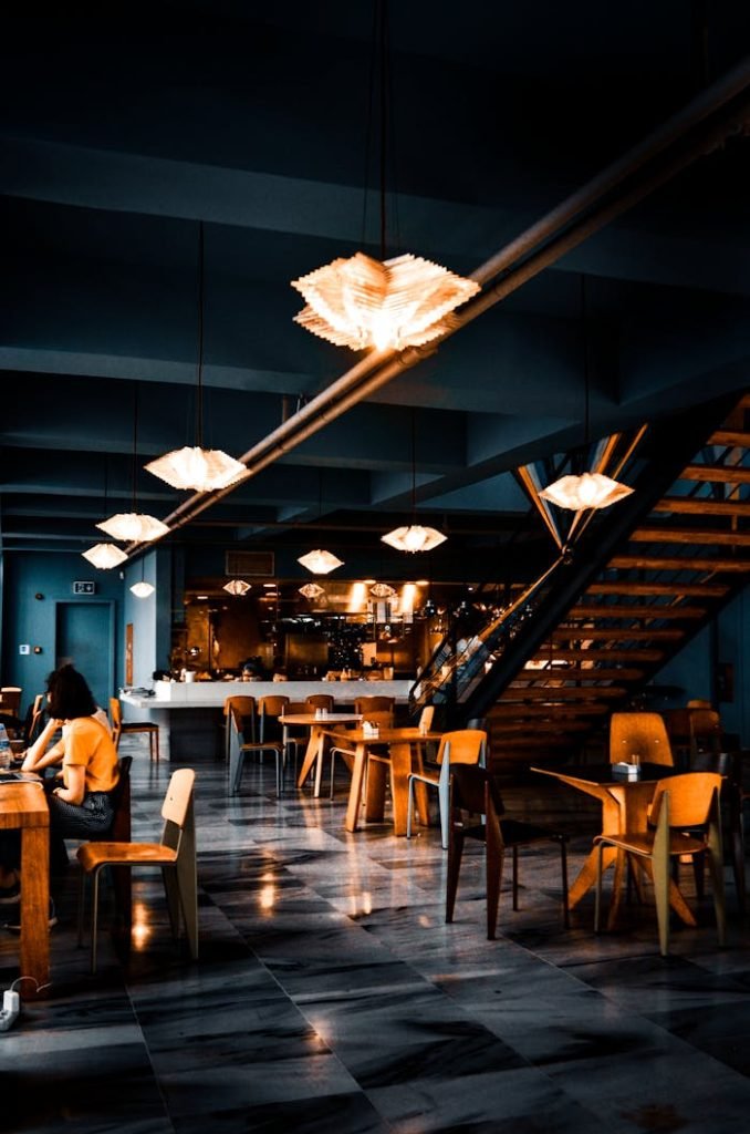 Elegant modern café with warm lighting and contemporary decor, creating a cozy atmosphere.
