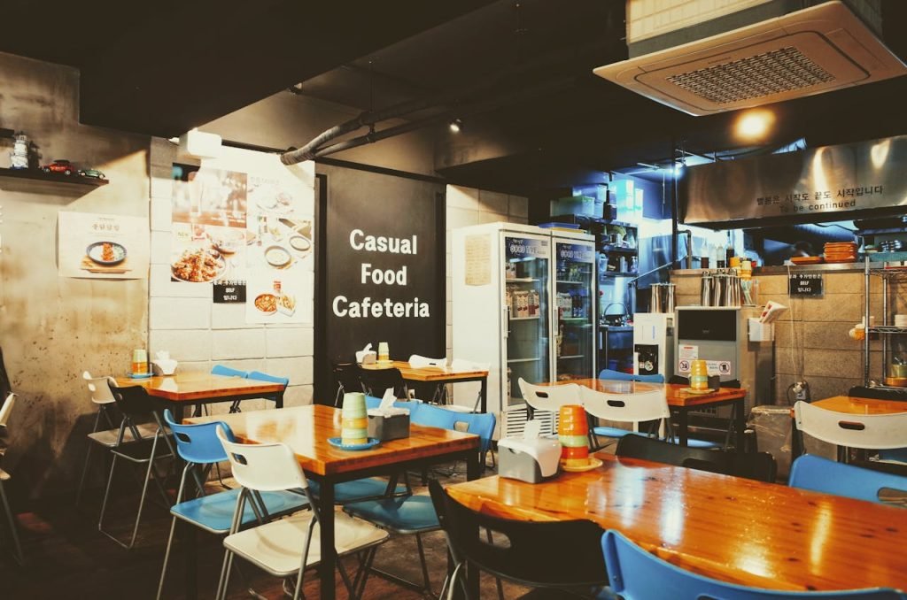 Crafting Captivating Headlines: Your awesome post title goes here A cozy casual cafeteria interior with tables and chairs, located in Busan, South Korea.